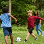 Family playing soccer