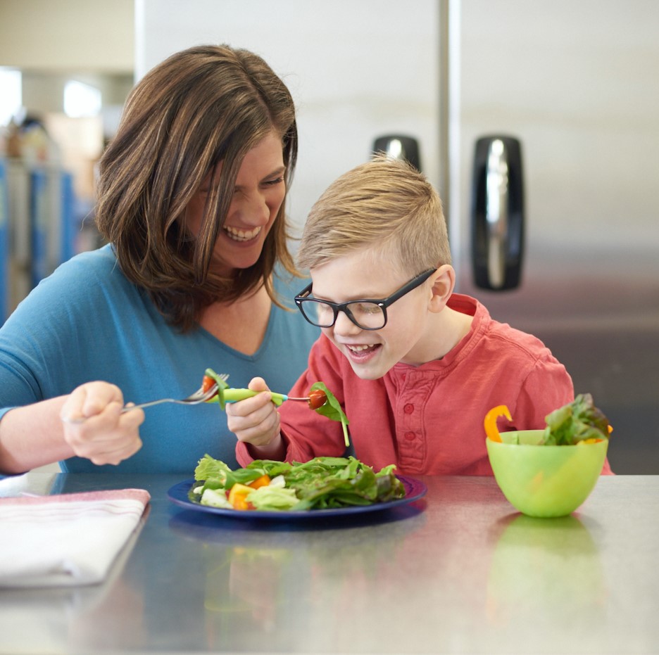 Mom and son eating salad